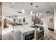Open-concept kitchen featuring stainless steel appliances, quartz counters, and seamless flow to the living area at 1459 W 42Nd Ave, Denver, CO 80211