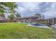 Large backyard featuring a well-kept lawn, brick house, trampoline, patio, and soccer goal, great for outdoor activities at 2560 Westchester Dr, Denver, CO 80221