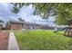 Expansive backyard with green grass, soccer goal, playground slide, patio, and trampoline, perfect for Gathering entertainment at 2560 Westchester Dr, Denver, CO 80221