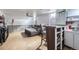 Finished basement featuring bar, stools, gray couch, mini-fridge, and wood look floors at 2560 Westchester Dr, Denver, CO 80221