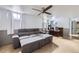 Finished basement with couch, bar with stools, drop ceiling and windows at 2560 Westchester Dr, Denver, CO 80221