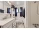 Bathroom featuring a shower, toilet, white vanity, mirror and dark curtains at 2560 Westchester Dr, Denver, CO 80221