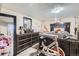 Bedroom with a bed, exercise bike, dresser, crib, and neutral decor at 2560 Westchester Dr, Denver, CO 80221