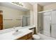 Bathroom with shower and bath combo with sliding glass doors and wood cabinets at 4498 Buena Vista Ct, Castle Rock, CO 80109