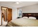 Cozy bedroom featuring a ceiling fan, large window and an ensuite bathroom at 4498 Buena Vista Ct, Castle Rock, CO 80109
