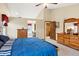 Bright bedroom features a vaulted ceiling, wood furnishings, ensuite bathroom, and walk-in closet at 4498 Buena Vista Ct, Castle Rock, CO 80109