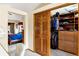 Walk-in closet featuring custom built-ins and organizers with the main bedroom in the background at 4498 Buena Vista Ct, Castle Rock, CO 80109