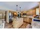 Well-lit kitchen showcases wood cabinets, granite counters, island, and stainless steel appliances at 4498 Buena Vista Ct, Castle Rock, CO 80109