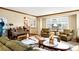 Comfortable living room with large windows, hardwood floors, and traditional furnishings at 4498 Buena Vista Ct, Castle Rock, CO 80109
