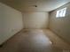 A partially finished basement with carpeted floors, white walls, and a small window at 5138 S Sedalia Ct, Centennial, CO 80015