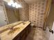 Bathroom features linoleum flooring, wallpaper, a double sink vanity, and a shower tub at 5138 S Sedalia Ct, Centennial, CO 80015