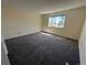 Bright bedroom featuring neutral walls, plush carpeting, and a large sunny window at 5138 S Sedalia Ct, Centennial, CO 80015