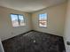 This bedroom features neutral walls, dark carpet, and two bright, large windows with outdoor views at 5138 S Sedalia Ct, Centennial, CO 80015