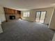 Expansive living area with a cozy brick fireplace and large windows at 5138 S Sedalia Ct, Centennial, CO 80015