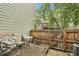 Private fenced backyard patio with seating area and mature trees at 1198 Milo Cir # A, Lafayette, CO 80026