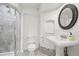 Updated bathroom featuring a tiled shower with glass door, modern toilet, and a pedestal sink at 1198 Milo Cir # A, Lafayette, CO 80026