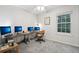 Bright, carpeted office space with a large desk, multiple monitors, and natural light from the window at 1198 Milo Cir # A, Lafayette, CO 80026