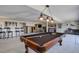 Entertaining basement with pool table, bar area, and motorcycle display, ideal for recreation at 51 West Ranch Trl, Morrison, CO 80465
