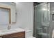 A modern bathroom with a sink, toilet, mirror, and shower with glass doors at 51 West Ranch Trl, Morrison, CO 80465