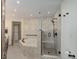 A luxurious bathroom featuring a soaking tub, shower with glass door, and tiled walls at 51 West Ranch Trl, Morrison, CO 80465