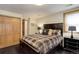 Comfortable bedroom featuring a plaid comforter, dark wood furniture, and cozy lighting at 51 West Ranch Trl, Morrison, CO 80465