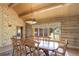 A dining room with wooden table and chairs with a large window showcasing views at 51 West Ranch Trl, Morrison, CO 80465