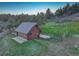 Cozy log cabin nestled in a wooded area, featuring a metal roof and fenced yard at 51 West Ranch Trl, Morrison, CO 80465