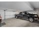 Attached garage with a black pickup truck and white door, offering convenience and security at 51 West Ranch Trl, Morrison, CO 80465