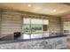Kitchen bar showcasing stone accents, modern countertop, and scenic outdoor views at 51 West Ranch Trl, Morrison, CO 80465
