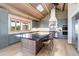 Gourmet kitchen featuring an expansive island, modern appliances, and abundant natural light at 51 West Ranch Trl, Morrison, CO 80465