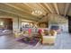Open-concept living area with stone accents, wood beams, fireplace, and scenic views at 51 West Ranch Trl, Morrison, CO 80465