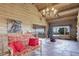Inviting living room with log walls, stone floors, comfortable seating, and scenic views at 51 West Ranch Trl, Morrison, CO 80465
