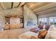 Open living room with stone fireplace and sliding barn doors, complemented by scenic views at 51 West Ranch Trl, Morrison, CO 80465