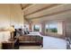 Spacious main bedroom featuring wooden ceiling, beams and a picturesque view from many windows at 51 West Ranch Trl, Morrison, CO 80465