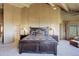 Warm bedroom with wooden ceiling beams, large windows, walk-in closet, and ensuite bath at 51 West Ranch Trl, Morrison, CO 80465