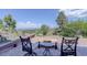 Inviting stone patio with seating, offering scenic views of the surrounding mountains and valley at 51 West Ranch Trl, Morrison, CO 80465