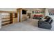 Finished basement with built-in shelves, entertainment center, and a unique red motorcycle on display at 51 West Ranch Trl, Morrison, CO 80465