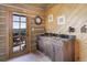 Convenient wet bar area featuring wood cabinets, a granite countertop, and an exterior view at 51 West Ranch Trl, Morrison, CO 80465