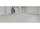 Open basement featuring carpet, a staircase, and white doors at 21204 E 63Rd Dr, Aurora, CO 80019