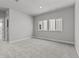 A carpeted bedroom with bright windows with white trim at 21204 E 63Rd Dr, Aurora, CO 80019