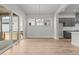 Open dining space featuring wood floors, sliding glass doors to patio, and modern chandelier at 21204 E 63Rd Dr, Aurora, CO 80019