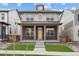 Charming two-story home featuring brick accents, a welcoming front porch, and a bright yellow front door at 21204 E 63Rd Dr, Aurora, CO 80019