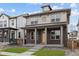 Inviting two-story home with a covered front porch and a brick facade in a Gathering-friendly neighborhood at 21204 E 63Rd Dr, Aurora, CO 80019