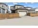 Exterior elevation featuring a two-car garage, ample parking and privacy fence at 21204 E 63Rd Dr, Aurora, CO 80019