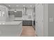 Modern kitchen featuring gray cabinets, stainless steel appliances, and a spacious quartz countertop island at 21204 E 63Rd Dr, Aurora, CO 80019