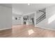 Open-concept living room with hardwood floors leads to a modern kitchen with gray cabinets at 21204 E 63Rd Dr, Aurora, CO 80019
