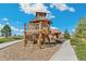 Unique wooden play structure with climbing nets, slides, and lookout tower for outdoor adventures at 21204 E 63Rd Dr, Aurora, CO 80019