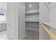 A roomy walk-in closet with built-in shelving and hanging rods for optimal storage at 21204 E 63Rd Dr, Aurora, CO 80019
