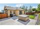 Backyard featuring a hot tub, patio, lush lawn, and mature trees for added privacy at 19677 E Vassar Dr, Aurora, CO 80013