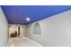 Finished basement with an archway and a seating area visible in the next room at 19677 E Vassar Dr, Aurora, CO 80013